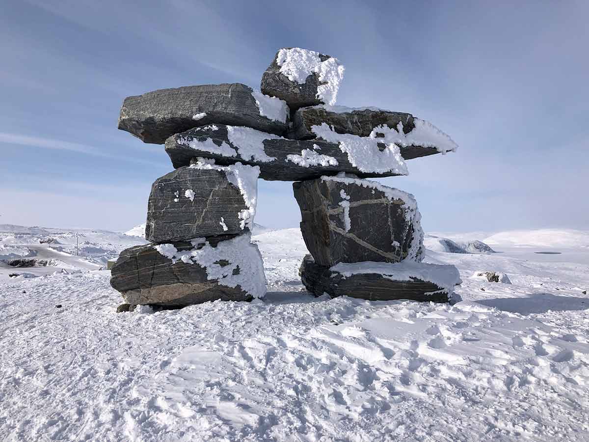 Inukshuk in a northern landscape representing Indigenous participation and long-term stewardship in mine water projects.